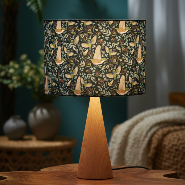 Hero lifestyle shot of table lamp with NZ forest birds fabric lampshade