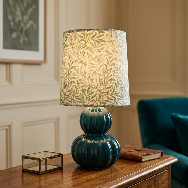 Illuminated Willow Boughs teal table lamp on a timber console