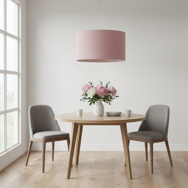 Dusky pink linen barrel ceiling pendant in stylish dining area with grey chairs
