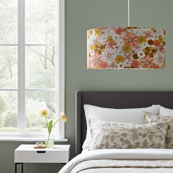 Pendant light in boho floral garden fabric above a bed in a bedroom with a window and nightstand.