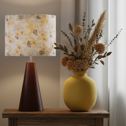 Decorative lamp with floral-patterned summer romance shade by shades at grays and yellow vase with dried flowers on a wooden surface.