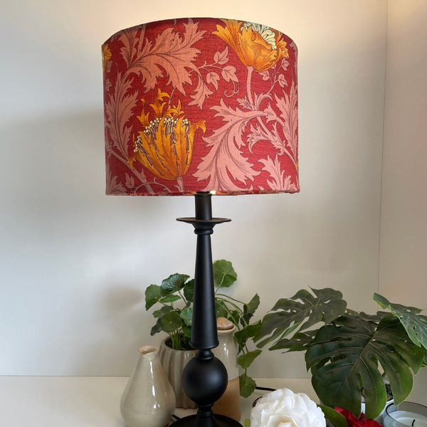 Shades at Grays Lampshades Morris & Co Deep Red bespoke fabric lampshade on black stand, lit.