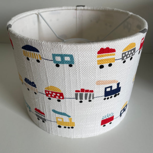 Bespoke childrens lampshade with trains on a white background, ceiling pendant.