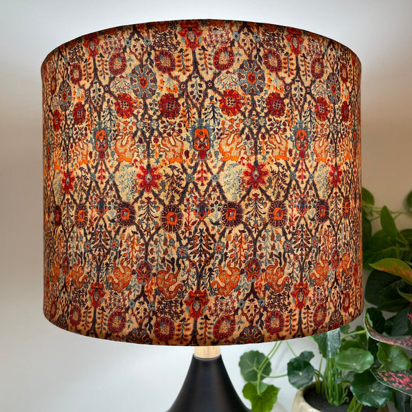 Close up of  handcrafted fabric lamp shade, on black touch lamp lit.