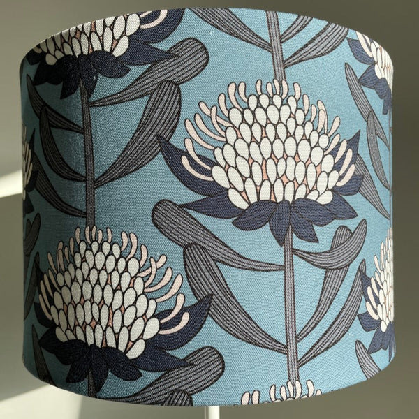 Blue and white waratahs fabric on medium drum lightshade.