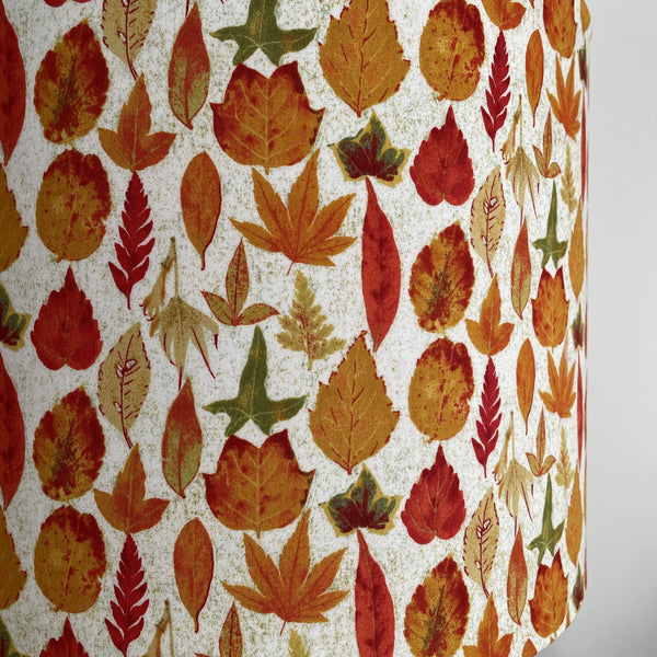 Close up of large handcrafted light shade with autumn leaves fabric.