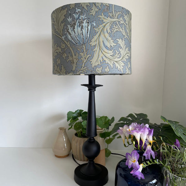 Blue and sage green floral and leave pattern. Morris and Co Anemone light blue. Bespoke fabric lampshade on black table lamp base.