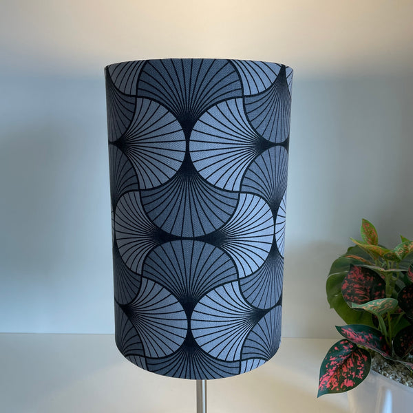 Grey geometric moon lampshade, lit.