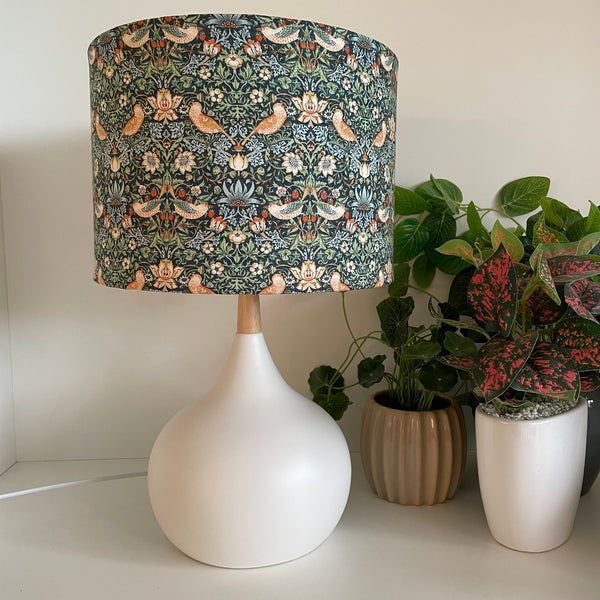 Handcrafted lamp shade on white touch lamp base, unlit.
