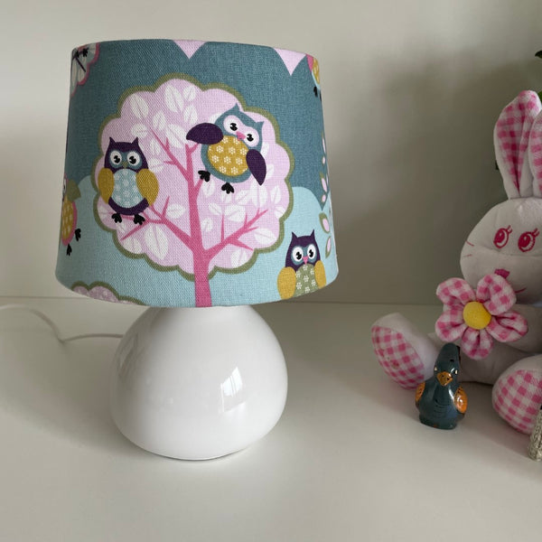 Handcrafted small tapered childrens lamp shade with owl pattern, unlit.
