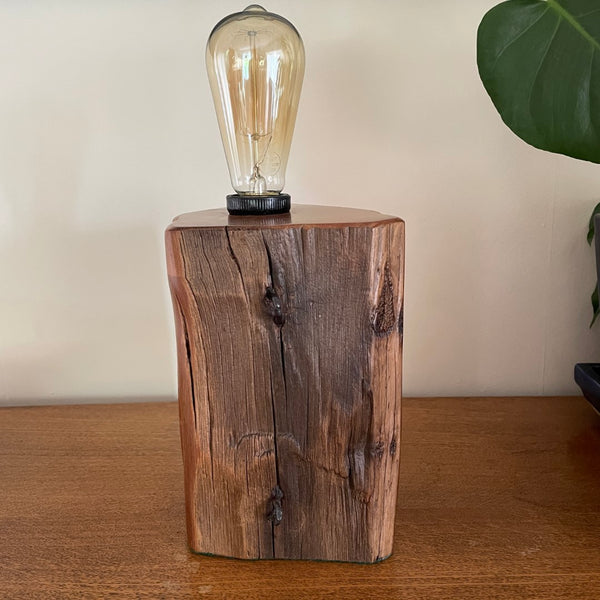 Handcrafted timber table lamp from old totara post with edison light bulb, unlit