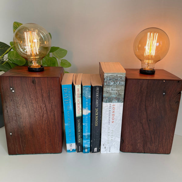 Handcrafted wooden table lamp book ends from jarrah telegraph post, with original nails. Lit.