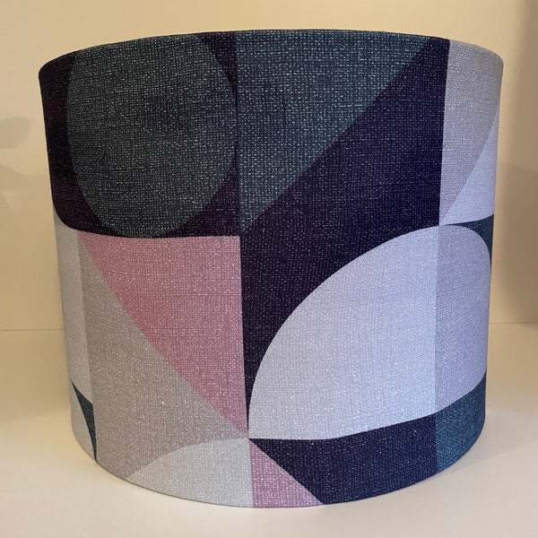 Large drum fabric lampshade, handcrafted, with geometric pink-grey fabric, unlit.