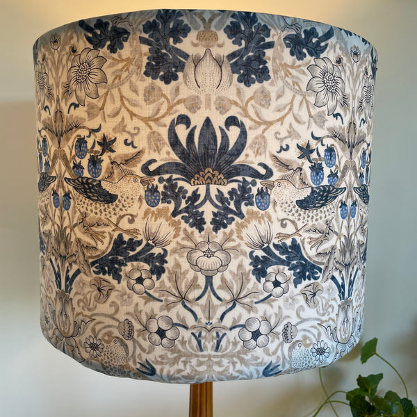 Large drum handcrafted lamp shade with William Morris fabric, lit.
