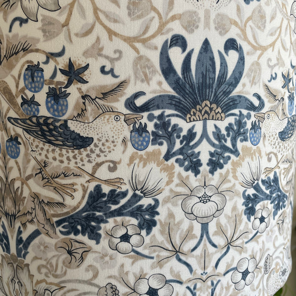 Large drum handcrafted lamp shade with William Morris fabric, unlit, close up..