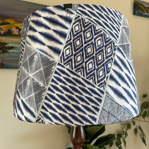 Large hand crafted lamp shade with blue dimensions fabric, unlit.