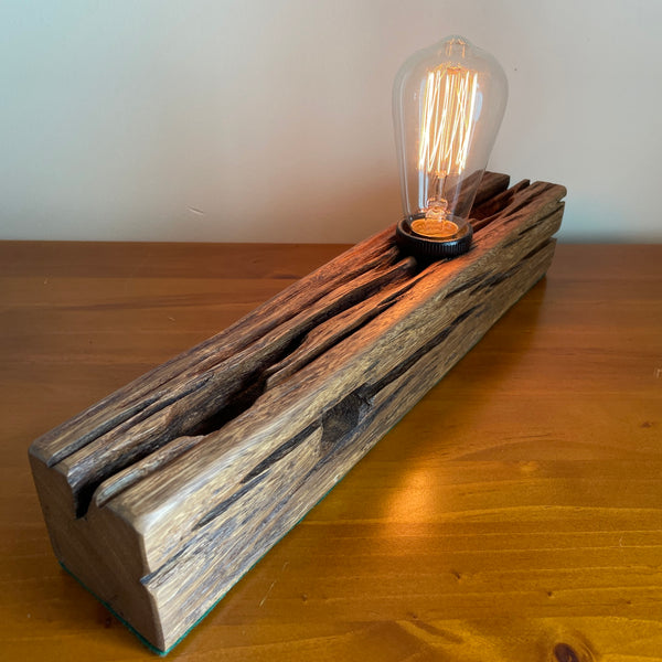 Unique table lamp with original markings, handcrafted from recycled telegraph post