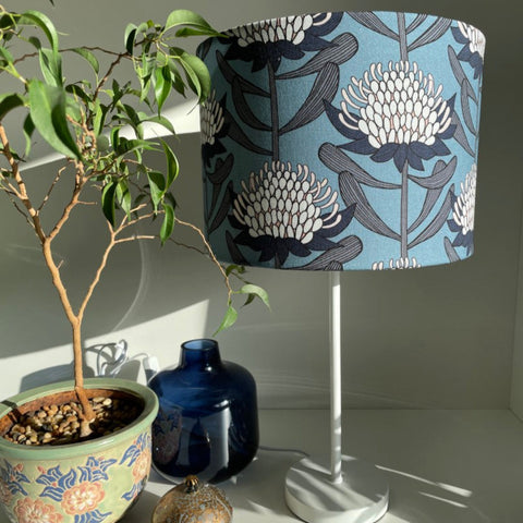 Blue and white waratahs fabric on medium drum light shade on white stand