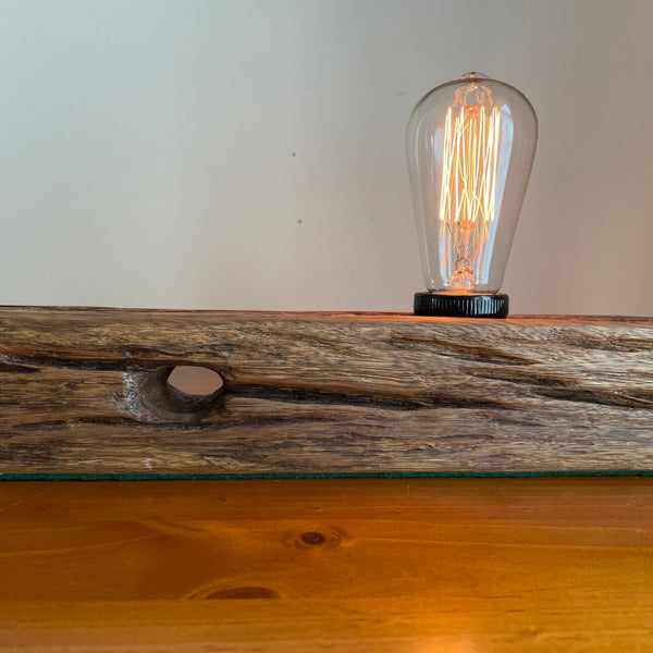 Close up of unique table lamp with original markings, handcrafted from recycled telegraph post