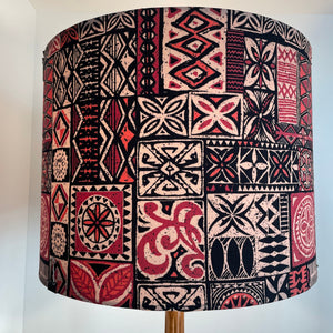 Pacific style tapa design on handcrafted fabric lamp shade, lit. Made in New Zealand.