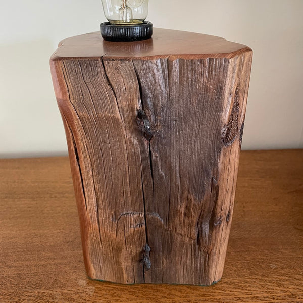 Front view of unique timber table lamp with polished grains of old totara post and original iron staples