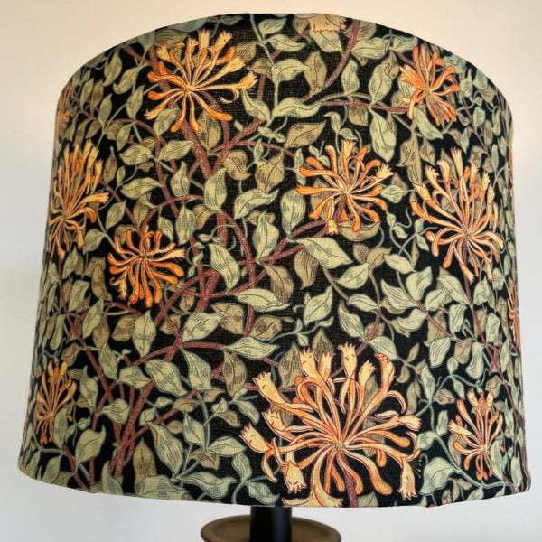Shades at Grays bespoke large fabric lampshade from Morris & Co honeysuckle black fabric. Lit. Close up.