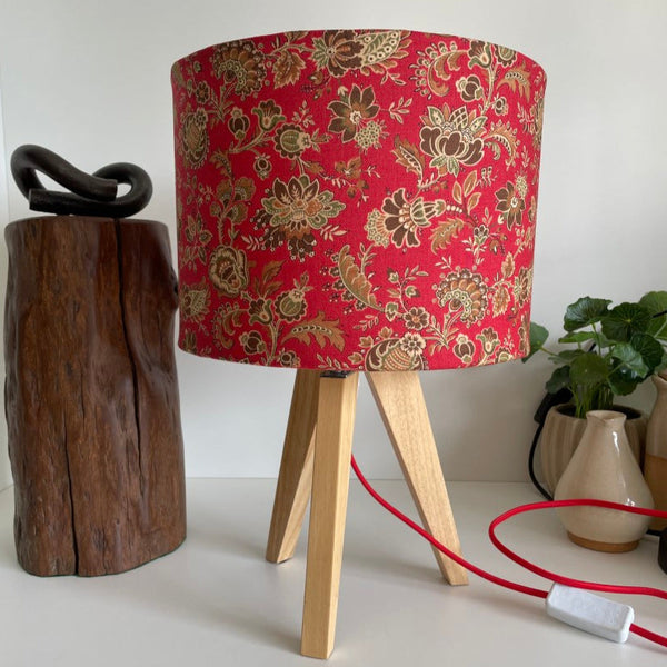 Shades at Grays bespoke medium drum fabric lampshade, French General Lavigne Rouge fabric. Unlit on natural wood tripod table lamp.