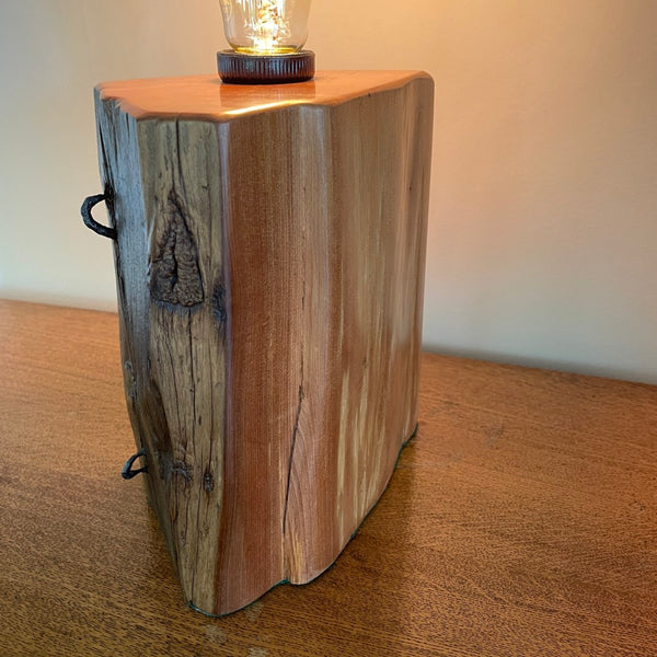 Smooth contrast of timber table lamp with original iron stables