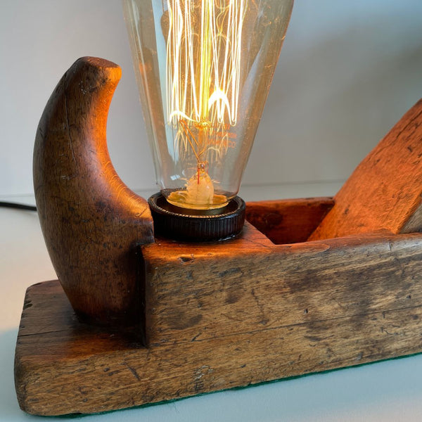 Timber table lamp upcycled from Bismark carpenter's wood plane and edision bulb, handle and toe close up.