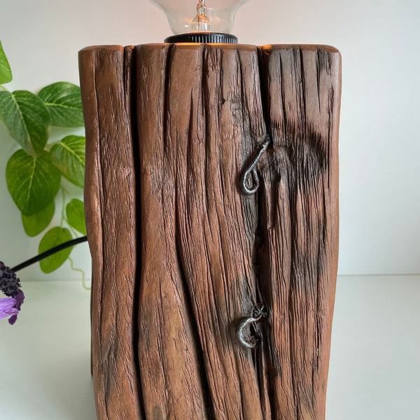 Two original staples on upcycled wooden table lamp with timber grain.