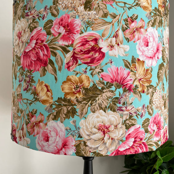 Variety of flowers on turquoise background on bespoke fabric light shade.