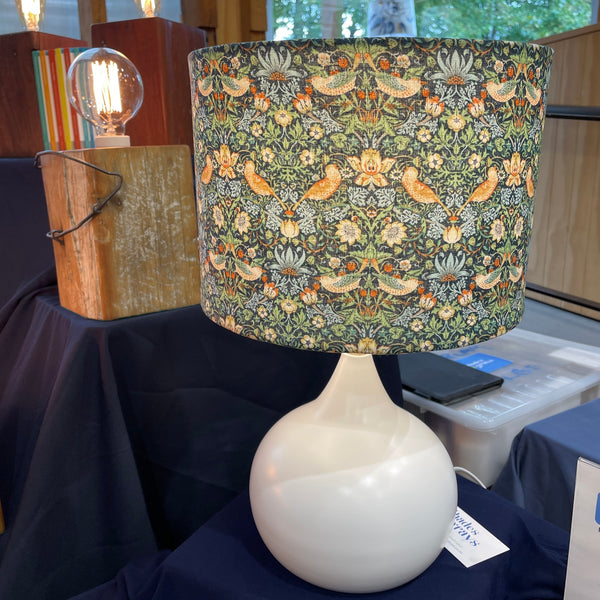 William Morris strawberry thief mini marine fabric lamp shade on white base at market stall, 