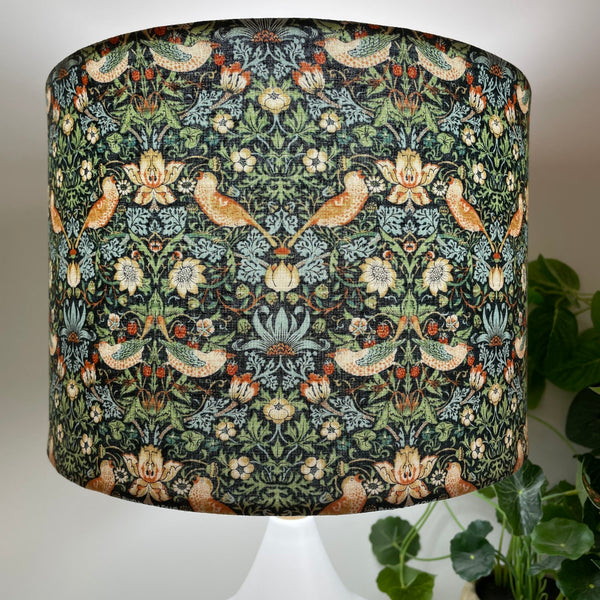 William Morris strawberry thief marine fabric on bespoke lamp shade, handcrafted in NZ. Close up, lit.