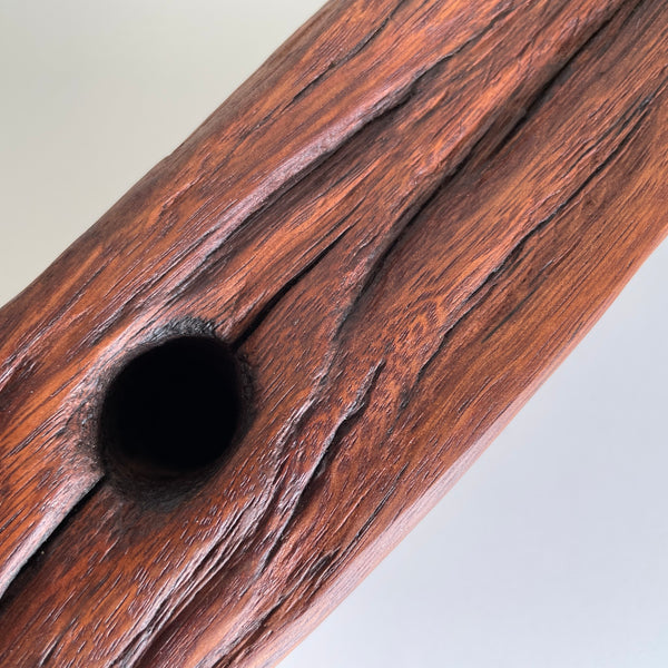 Close up of retained eroded hole on wooden table lamp handcrafted from old telegraph post.