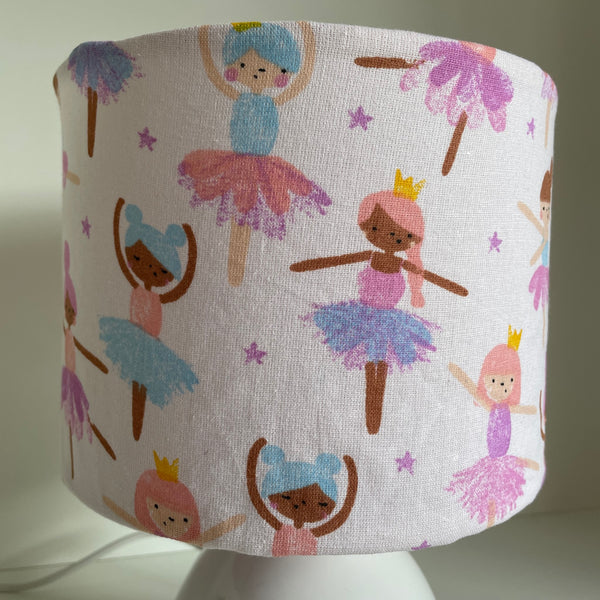 Young ballerina figures dance on a soft cream background, small fabric light shade.